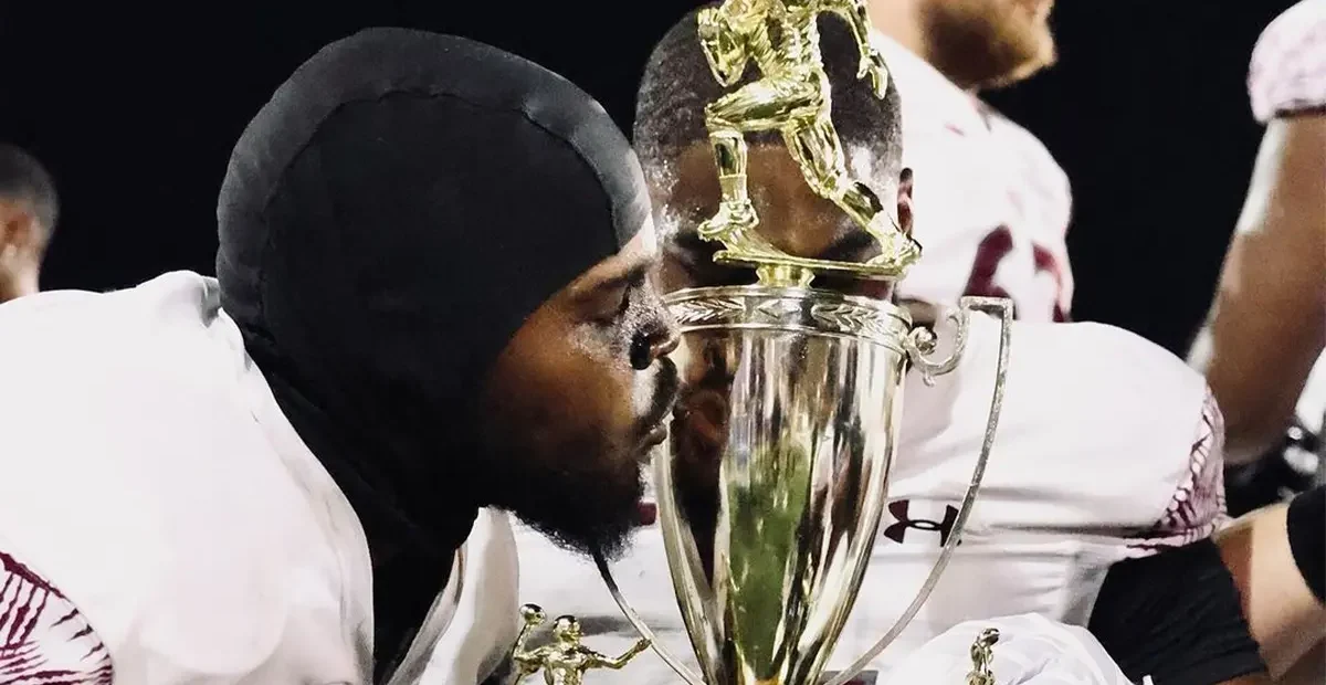 Texas Southern Football players kissing Labor Day Classic Trophy